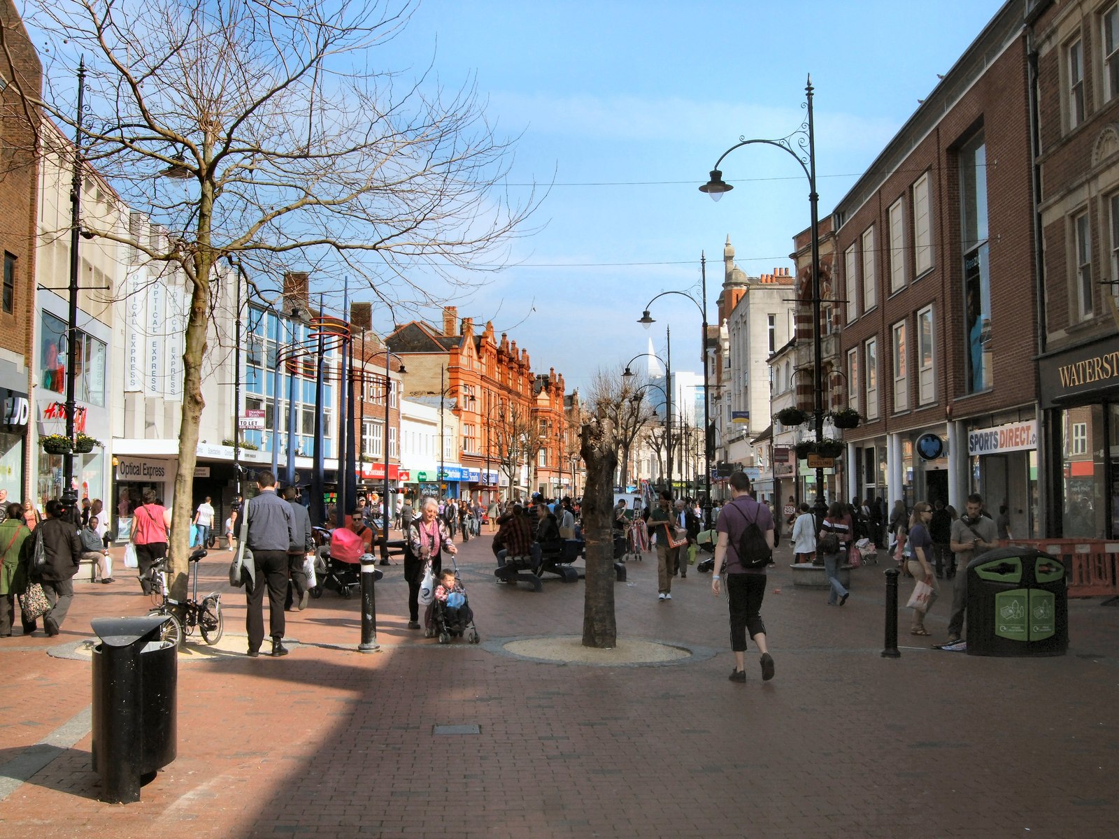 A busy pedestrian street scene with shops and people walking, reflecting the vibrant culture explored on Filmi.