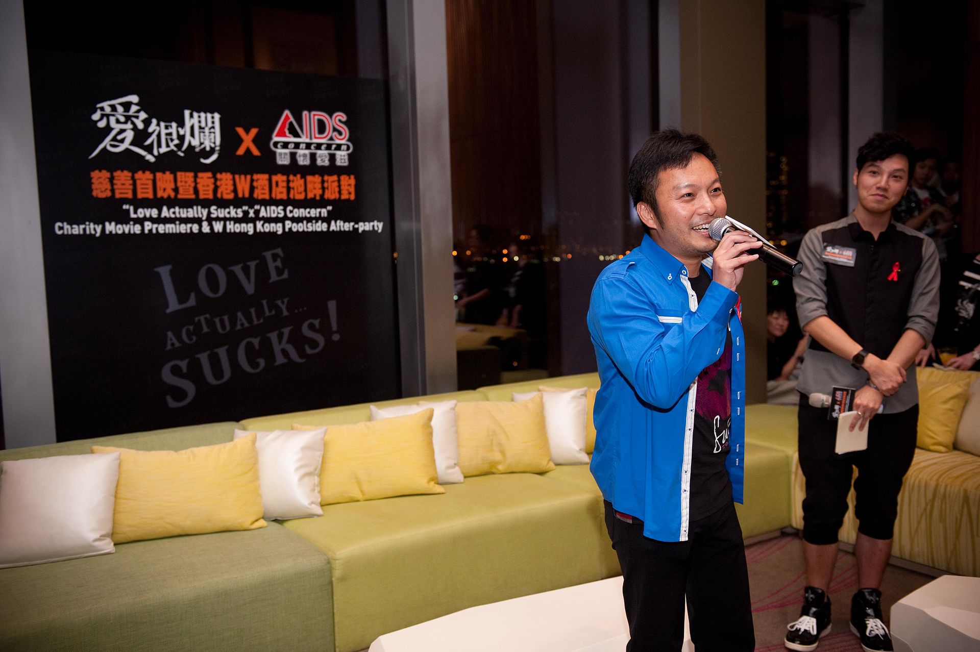A singer performs at a charity movie premiere event in Hong Kong, supporting AIDS Concern and promoting Indian cinema.